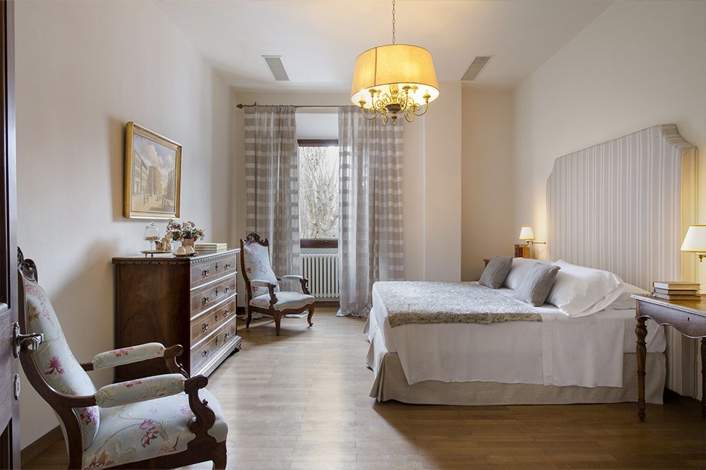 Beige bedroom of the luxury wedding resort in the Tuscan countryside