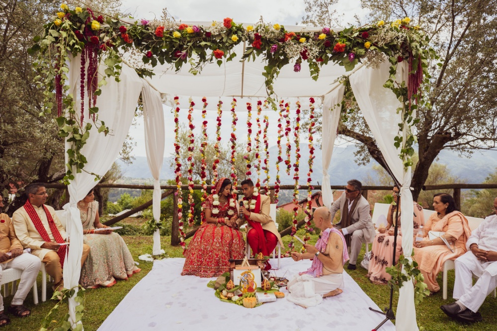 Bride and groom under mandap at the luxury wedding venue in Lucca