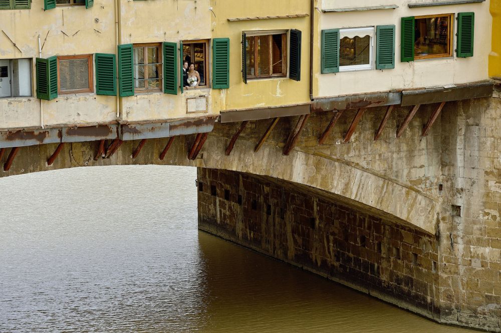 Bride and groom by the Old Bridge in Florence