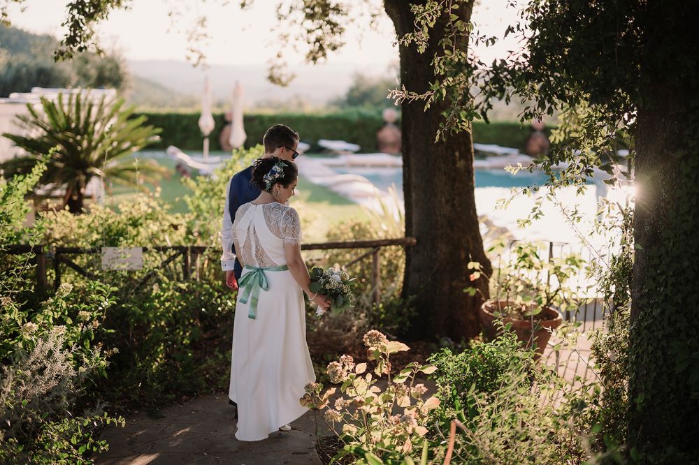 Bride and groom with pool at the Tuscan farmhouse for weddings