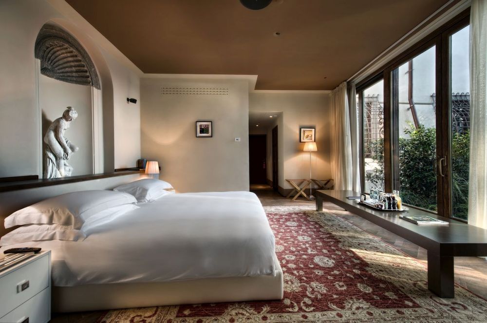 Ivory and burgundy bedroom at the luxurious hotel in Florence