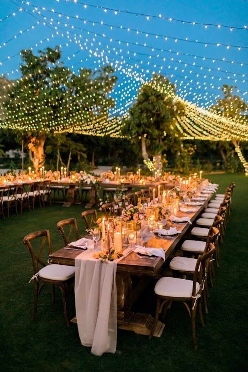 Long wooden tables with fairy lights