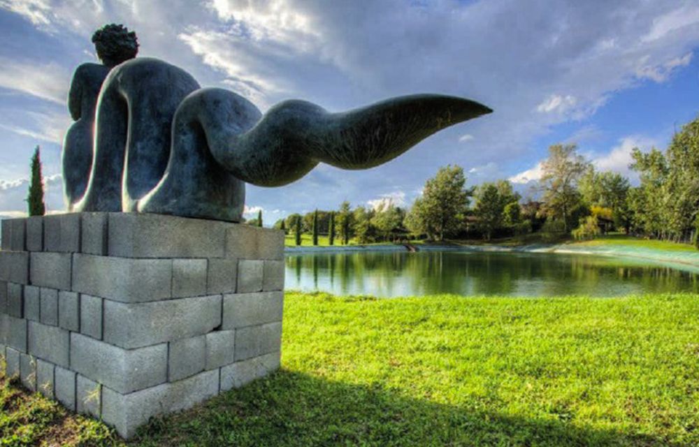 View of the lake and statue at the dream wedding hamlet in Tuscany