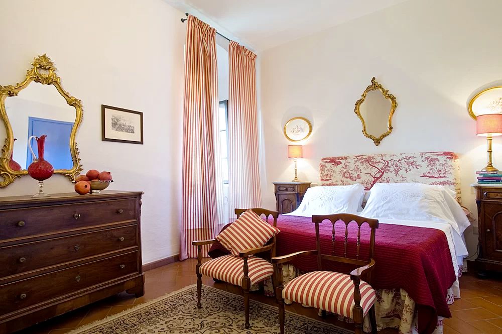 White and red bedroom at the romantic villa in Tuscany